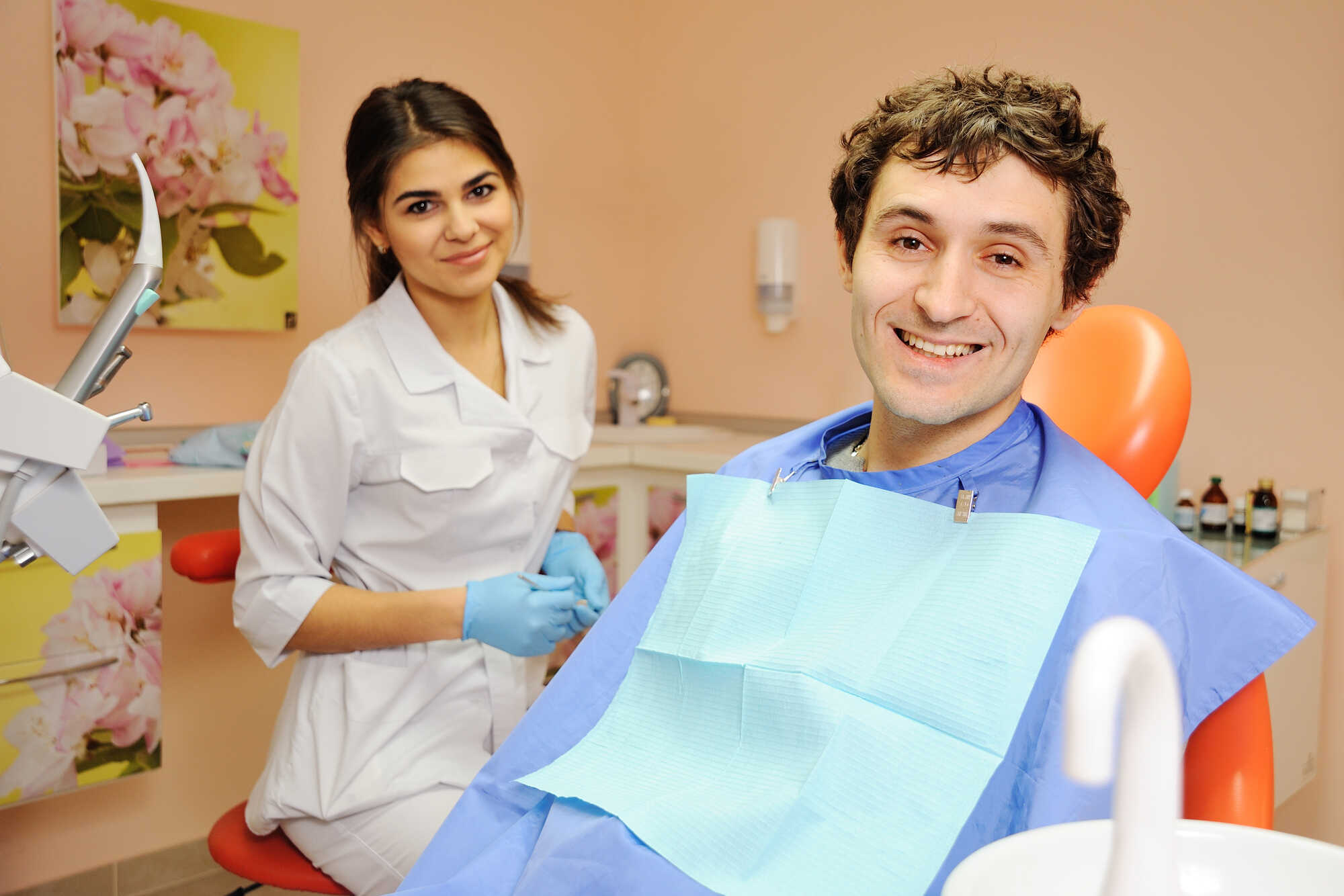 young guy on reception at the dentist girl